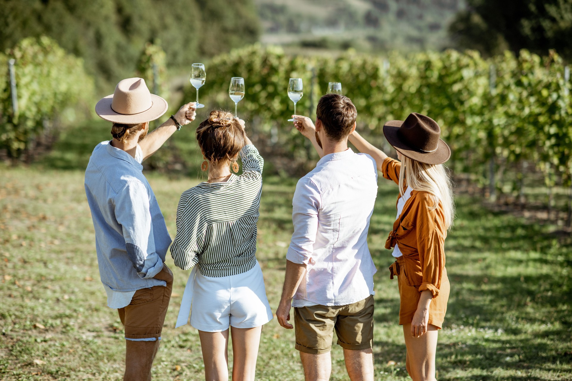 Friends tasting wine on the vineyard